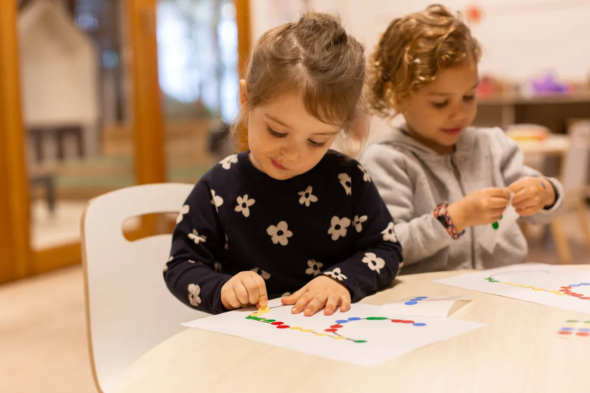 Two children focused on a craft activity