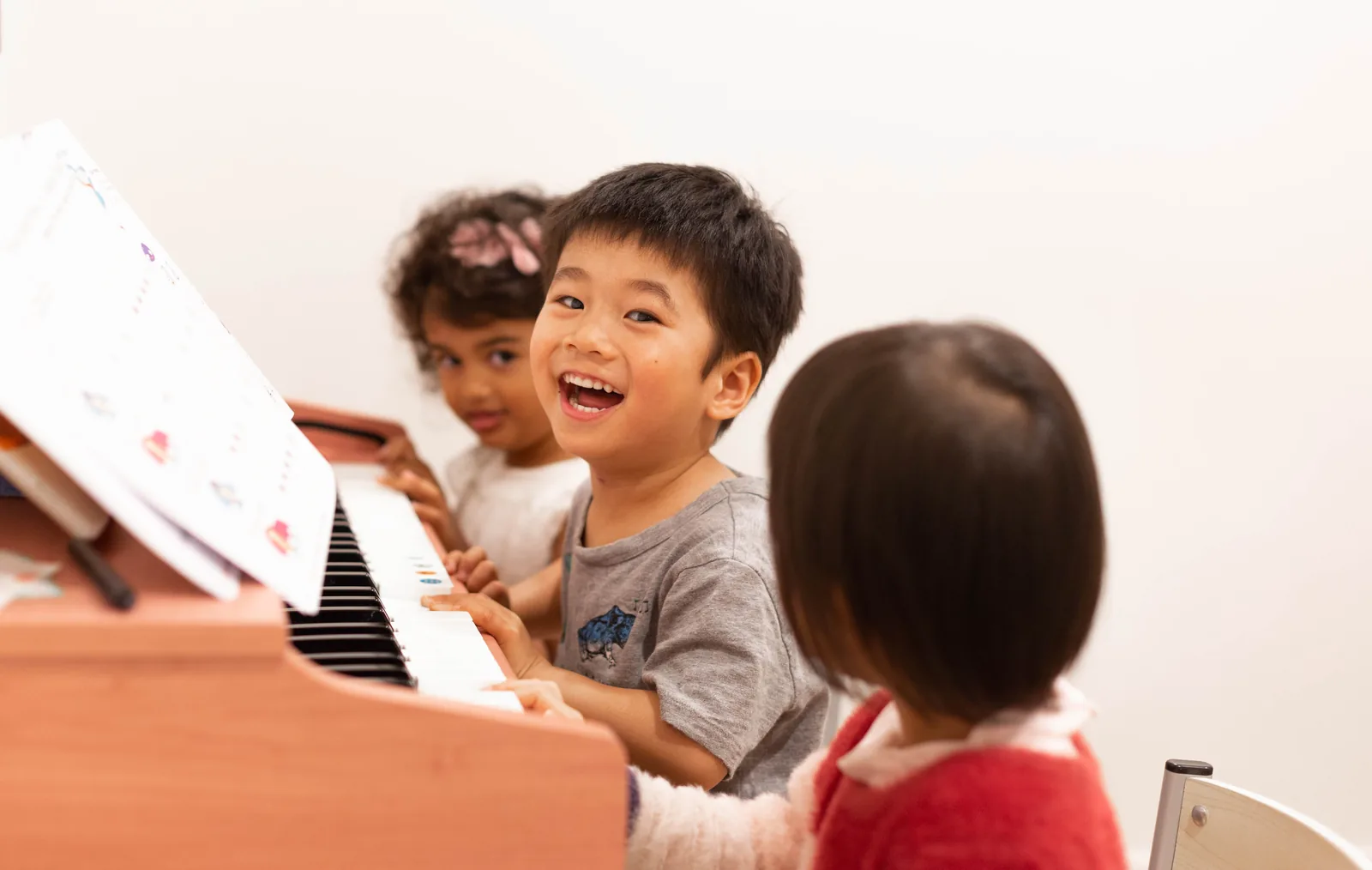 A child playing a toy piano